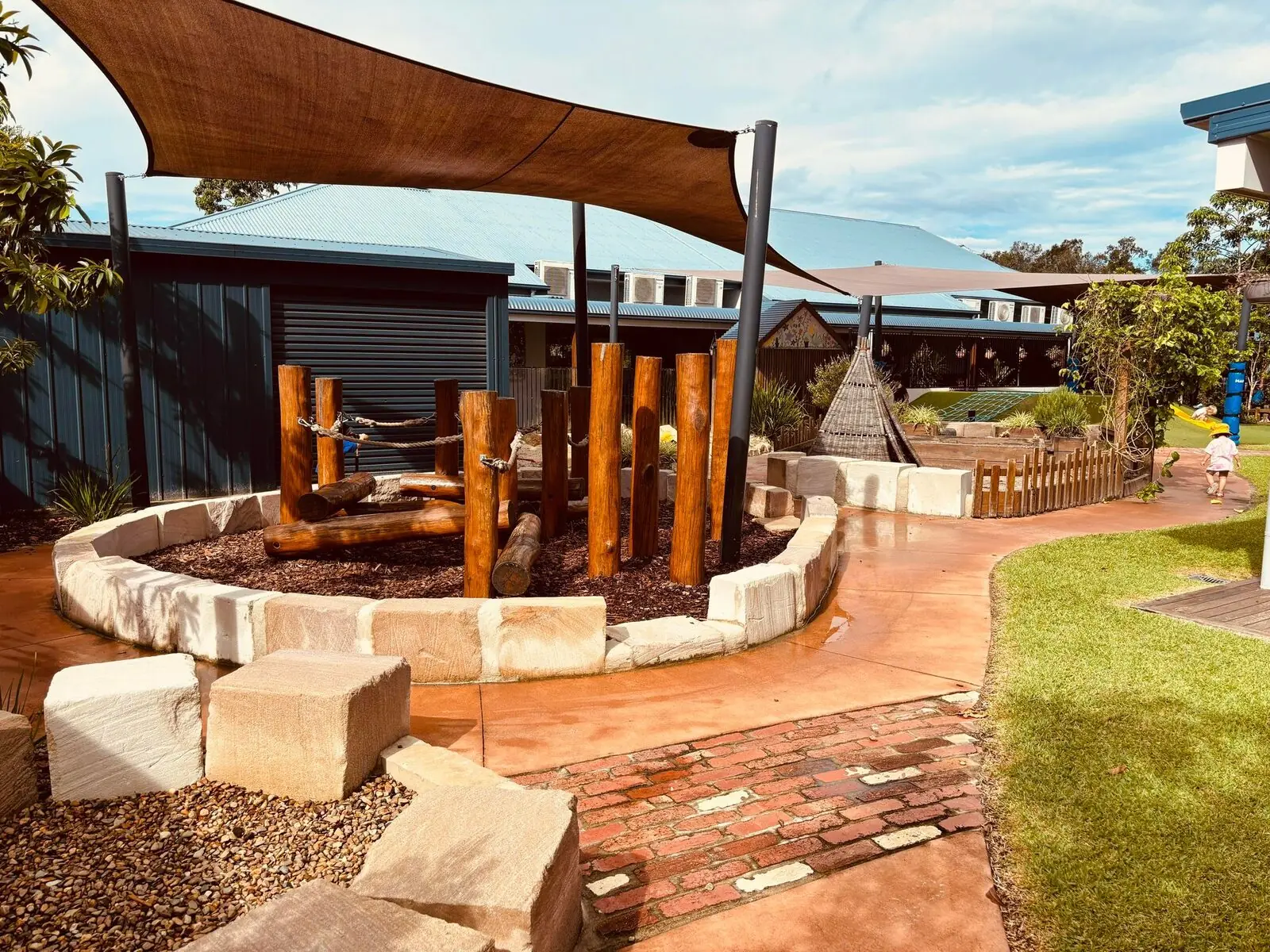 Children gathered in the outdoor stone seating circle